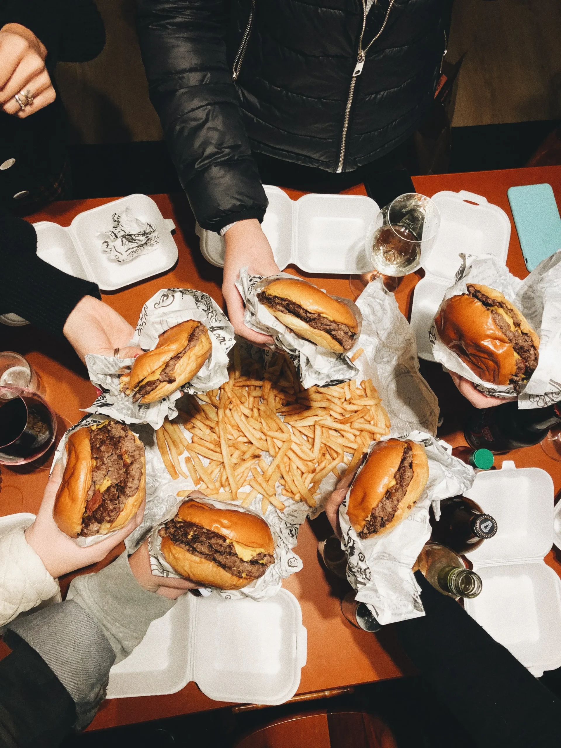 Friends sharing burgers at a table